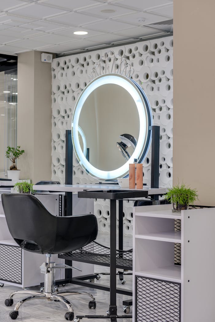 hero-img-01 Elegant salon interior featuring a stylish setup with a ring light and mirror.